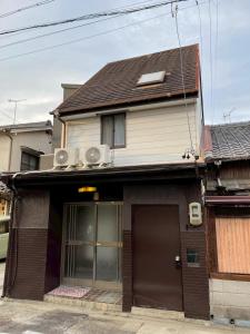 a house with a garage and a roof at Modern style old house in Nagoya