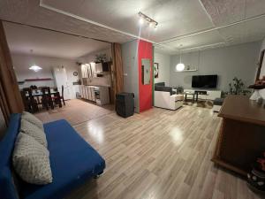 a large living room with a blue couch and a living room at Apartmán Renata in Rudník