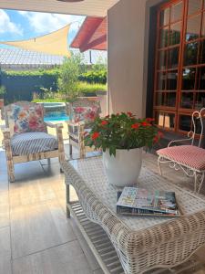 a wicker table with a potted plant on a patio at 24 on Fuschia in Welkom