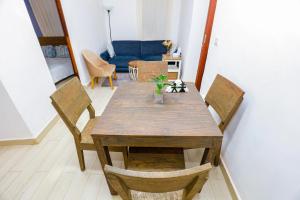 a wooden table and chairs in a living room at CoastalCharms Zanzibar in Zanzibar City +10 photos