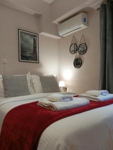 a bedroom with a bed with towels on it at LD Studio Larissa in Larisa