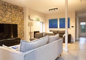 a living room with a couch and a fireplace at Arbide House in Leioa