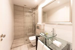 a bathroom with a glass sink and a toilet at Arbide House in Leioa +30 photos