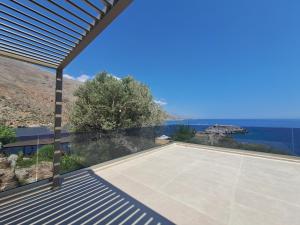 a view of a tennis court from a house at Castella Luxe in Loutro