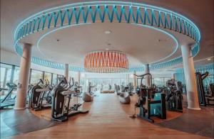 a gym with treadmills and ellipticals in a building at higuerón Aqualis in Torremuelle