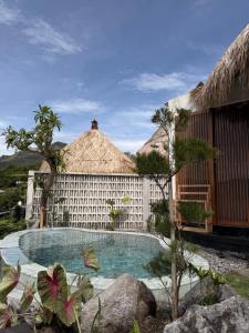 a resort with a swimming pool and a building at Santhi Loka in Kubupenlokan