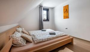 a bedroom with a bed with pillows on it at Chata Drienka in Terchová