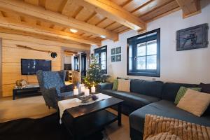 a living room with a couch and a table at Chata Drienka in Terchová