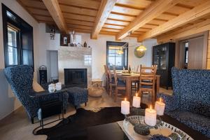 a living room with a table and chairs and a fireplace at Chata Drienka in Terchová
