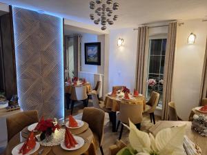 a restaurant with tables and chairs with food on them at Vila Rosa in Spišský Štvrtok