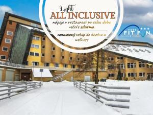 a picture of a building in the snow at Hotel Fit Fun in Harrachov