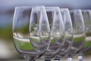 a row of wine glasses sitting on a table at Tupungato Divino in Tupungato
