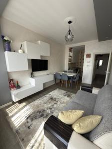 a living room with a couch and a dining room at Appartamento Venezia in Marghera