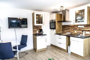 a kitchen with white cabinets and a counter top at Ferienwohnung Elsbeth in Biberach an der Riß