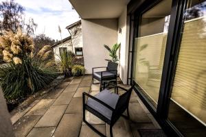 a patio with two chairs and a window at Ferienwohnung Elsbeth in Biberach an der Riß