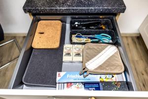 an open drawer with various items in it at Ferienwohnung Elsbeth in Biberach an der Riß