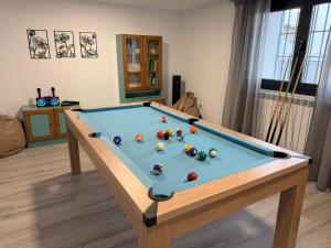 a pool table with balls on it in a living room at Campos de Villalba in Villalba