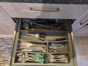 a drawer full of utensils in a cabinet at La dimora nelle Rue in Civitella Roveto +63 photos
