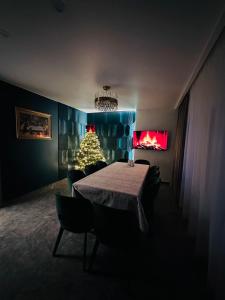a dining room with a table and a christmas tree at Brick House in Slavske