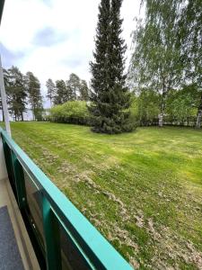 a view of a green yard from a balcony at Kylpylä-hotelli 261 in Ikaalinen