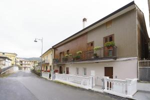 a building with balconies and plants on a street at Il Vecchio Pozzo Apartments in Ostigliano