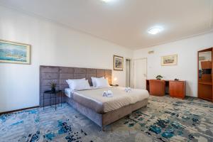 a bedroom with a large bed in a room at Hotel Bojatours in Podgorica +91 photos