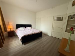a bedroom with a bed and a window and a door at Authentic sleeping in the city center in Leeuwarden