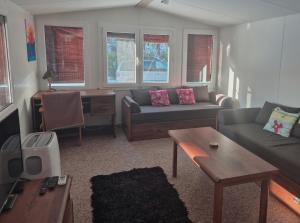 a living room with a couch and a table at Sauna v lese in Uhrovec