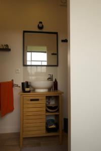 a bathroom with a sink and a mirror at LE Petit Ru 10 MN DE GIVERNY in Saint-Marcel