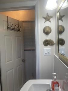 a bathroom with a sink and a mirror at Albury's Haven in Nassau