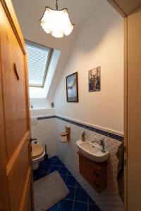 a bathroom with a sink and a toilet and a window at CHALET MACESEN Apartment Mauro with sauna - in the center of Kranjska gora in Kranjska Gora +21 photos