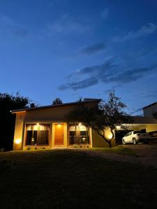 a house with a car parked in front of it at La Madriguera de Potrerillo in Alta Gracia