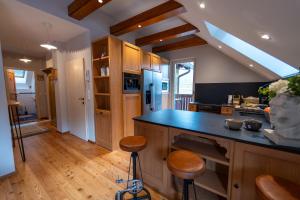 a kitchen with a blue counter top and wooden cabinets at CHALET MACESEN Apartment Mauro with sauna - in the center of Kranjska gora in Kranjska Gora