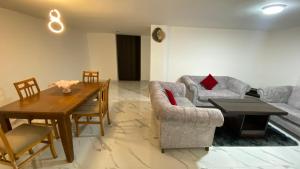 a living room with a couch and a table at W3 property in Kerak