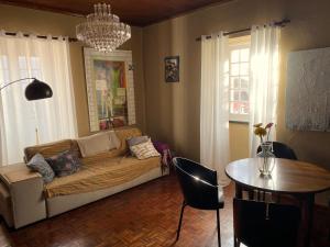 a living room with a couch and a table at Casa-Stella-Azores in Capelas