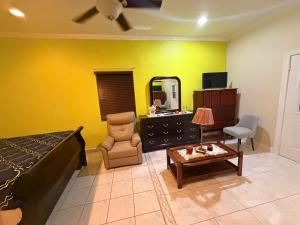 a bedroom with a bed and a mirror and a table at Cozy Nest in George Town