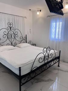 a bedroom with a large bed with a black frame at Boutique Penthouse by Weizmann - פנטהאוס בוטיק in Rechovot