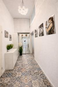 a hallway with a tile floor and pictures on the wall at 2 Room Galerie Einliegerwohnung in Rheinstetten, Messe Nähe, Rollstuhlfahrer geeignet in Rheinstetten