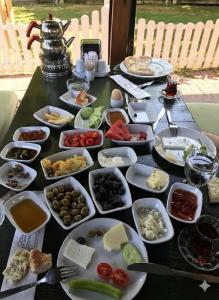 a table with many plates of food on it at Gonul Pansiyon in Kaleucagız