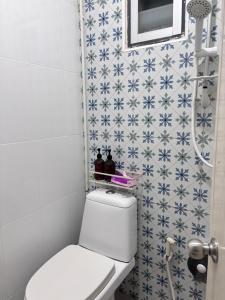 a bathroom with a toilet and blue and white tiles at Stay Together 3BR walkable to Nimman 6 Guests in Chiang Mai