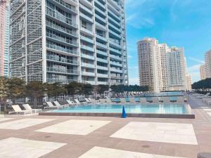 a swimming pool in a city with tall buildings at Sun&Sea IconBrickell Unit in Miami