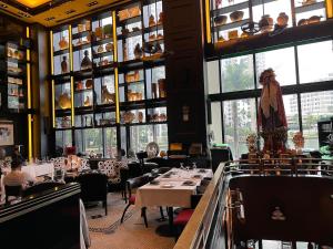a dining room with tables and chairs and windows at Sun&Sea IconBrickell Unit in Miami