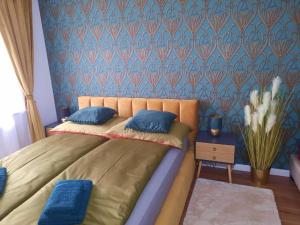 a bedroom with a bed with a blue wall at Deluxe Suite in Vienna