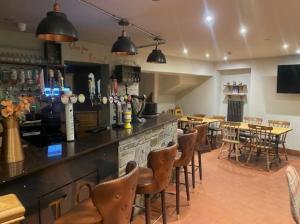 a bar in a restaurant with chairs and tables at Quarrymen's Arms in Nant-y-bwch