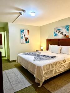 a bedroom with a bed and a ceiling fan at Rocky Mountain Lodge & Suites in Renfrew