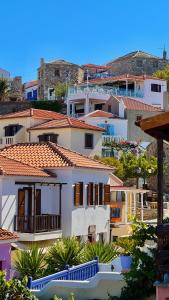 a group of buildings with roofs and trees at Chora Suite in Alonnisos