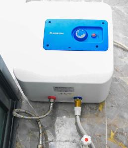 a water heater with a hose hooked up to it at 3Tee Serviced Apartment Abeokuta in Abeokuta +46 photos