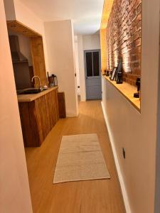 a kitchen with a counter and a brick wall at Refuge Éclatant Paray 4 couchages in Paray-le-Monial +8 photos