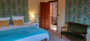 a bedroom with a bed and a chair and a window at Les Tourelles in Contes