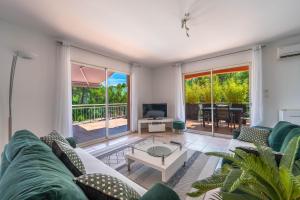 a living room with a couch and a table at LA BASTIDE DU MAZEL in Banne